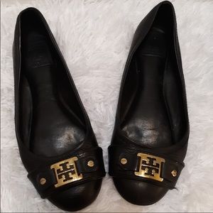 Tory Burch flats with square gold buckles.